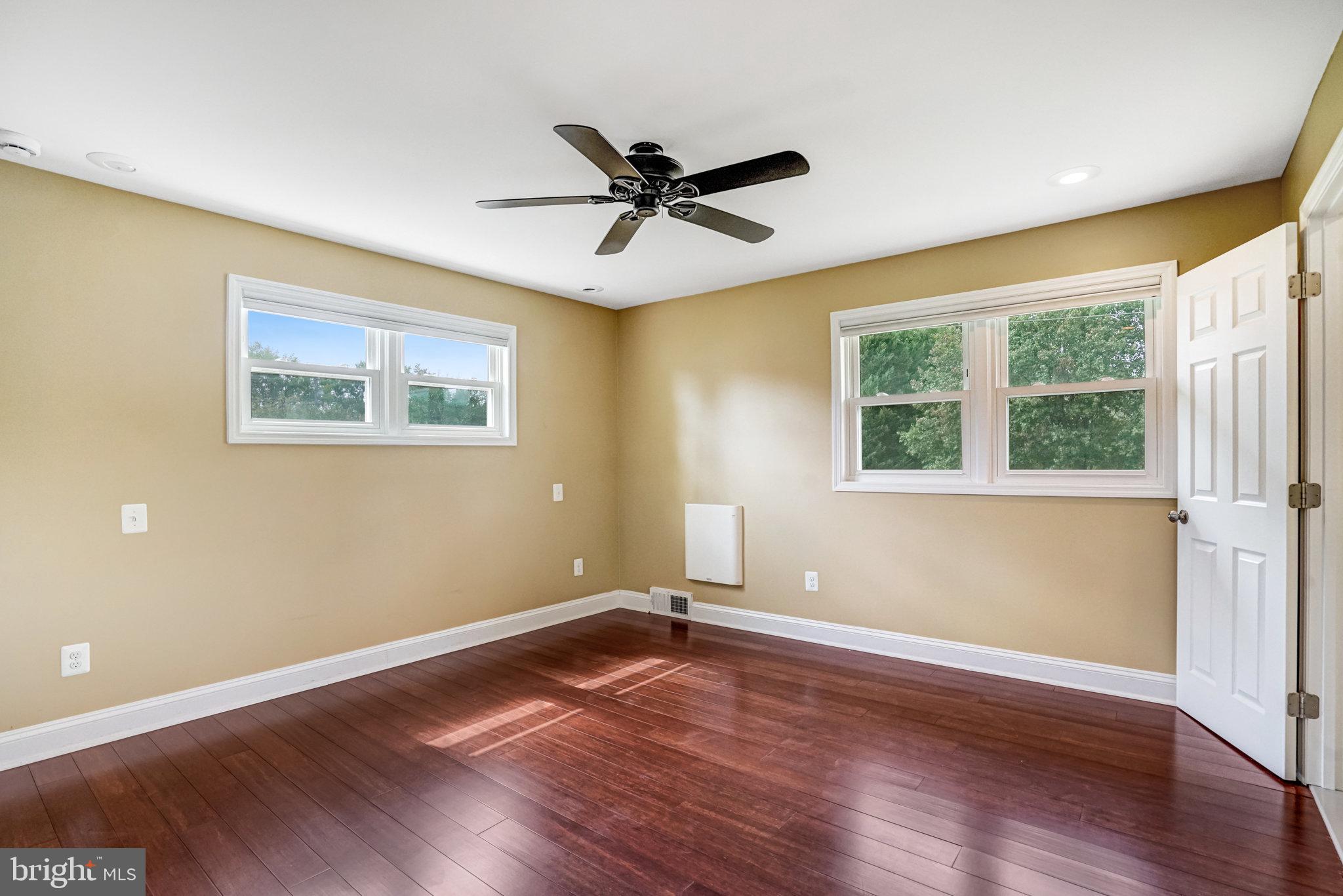 5227 Cather Road Springfield, VA 22151 - Photo 8 of 72 a view of empty room with wooden floor and fan
