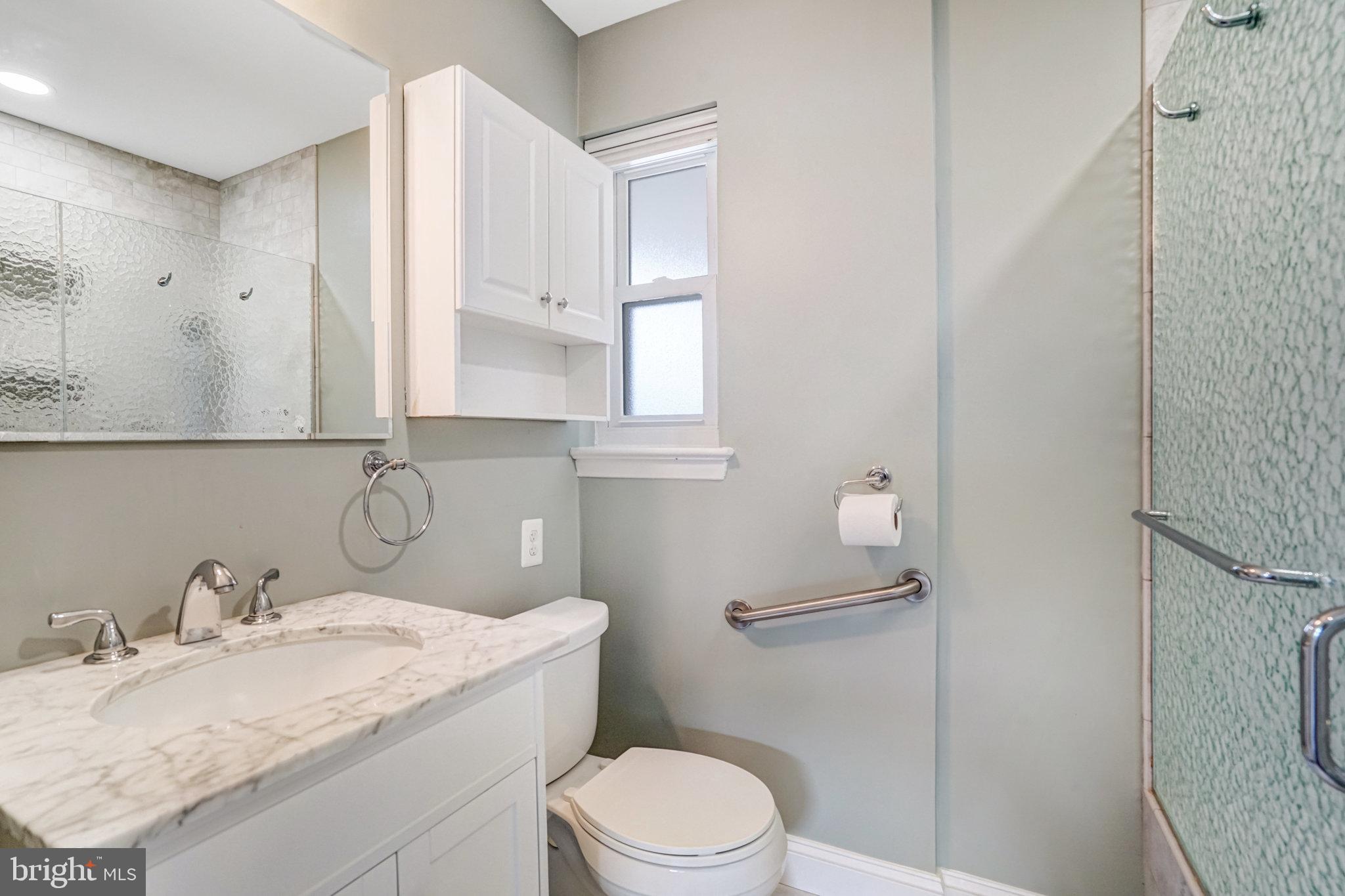 5227 Cather Road Springfield, VA 22151 - Photo 10 of 72 a bathroom with a granite countertop sink toilet and mirror