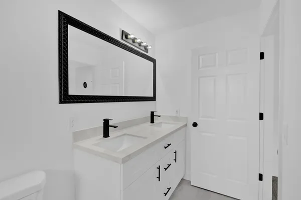 a bathroom with a sink vanity and mirror