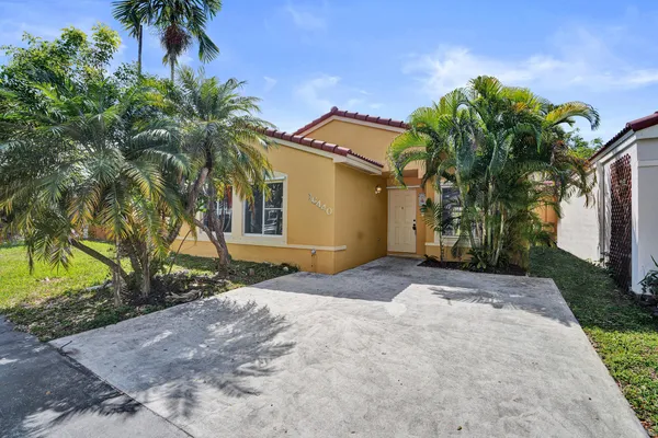 a front view of a house with a yard and a garage