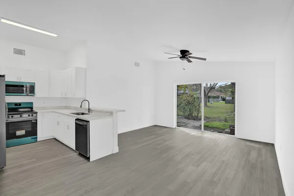 a view of kitchen with sink and window