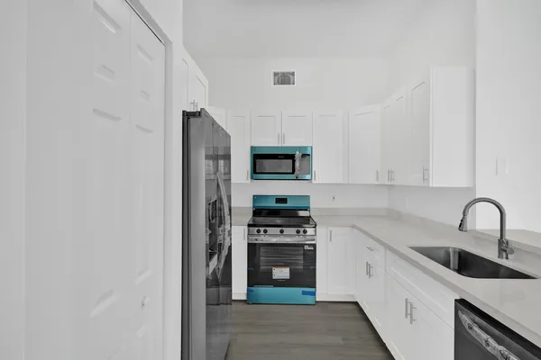 a kitchen with stainless steel appliances granite countertop a stove and a refrigerator