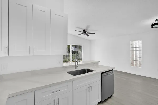 a kitchen with a sink cabinets and window