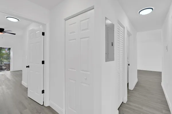 a view of a hallway with wooden floor