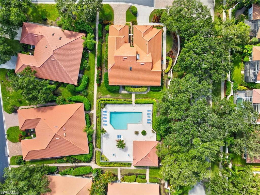 181 Napa Ridge Road East, Unit 35 Naples, FL 34119 - Photo 19 of 21 Aerial view of a residential community featuring tile roofs and lush landscaping