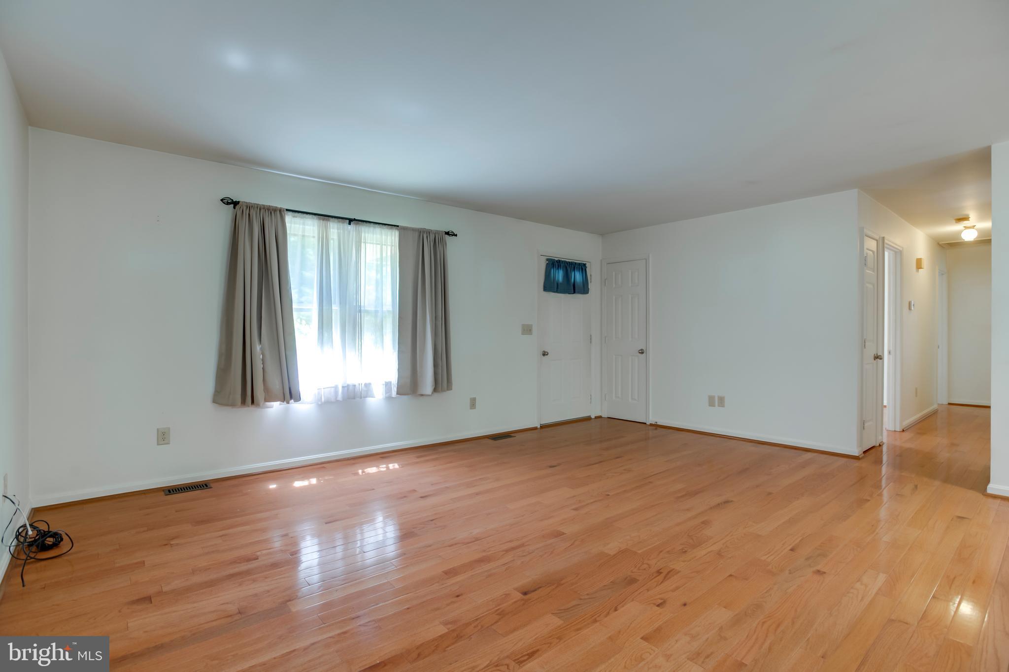 803 Weaver Hollow Road Banco, VA 22711 - Photo 4 of 67 an empty room with wooden floor and windows