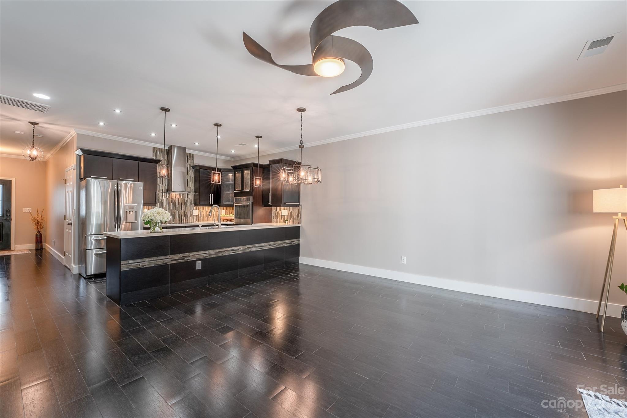 2135 Midnight Blue Lane Fort Mill, SC 29708 - Photo 8 of 22 a room with stainless steel appliances kitchen island granite countertop a refrigerator a stove and a wooden floors
