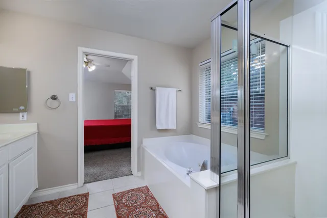 a bathroom with a tub sink toilet and mirror