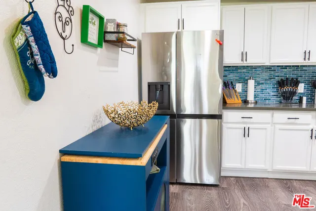 a kitchen with stainless steel appliances granite countertop a stove and cabinets