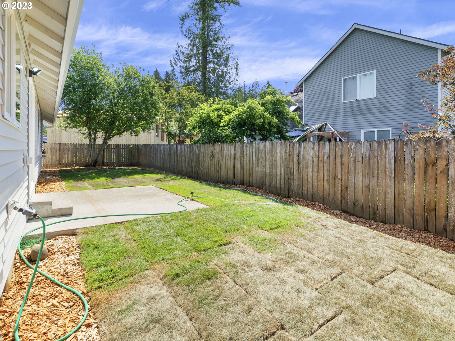 15268 Penny Avenue Sandy, OR 97055 - Photo 33 of 35 a view of a backyard with a wooden fence