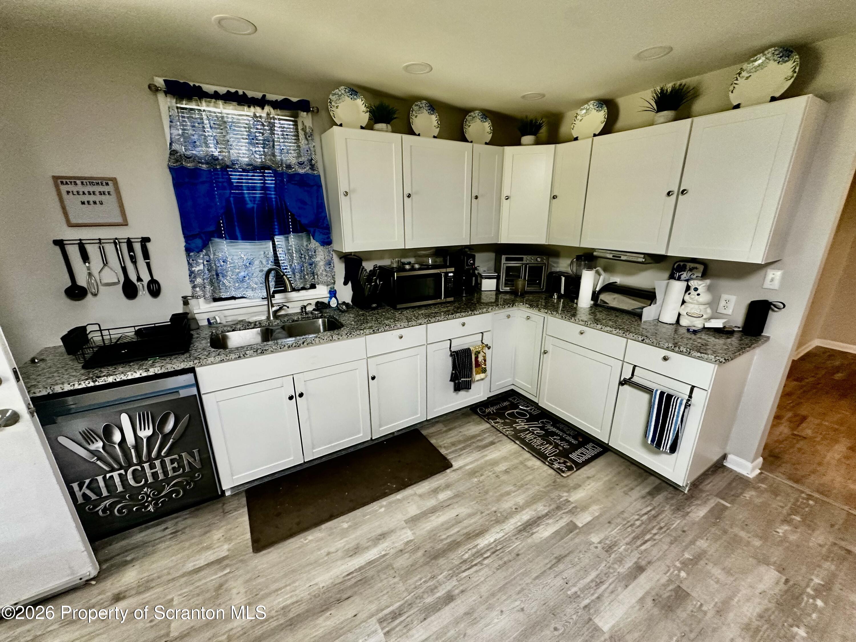 1727 Bulwer Street Scranton, PA 18504 - Photo 11 of 40 a kitchen with a sink a stove and cabinets