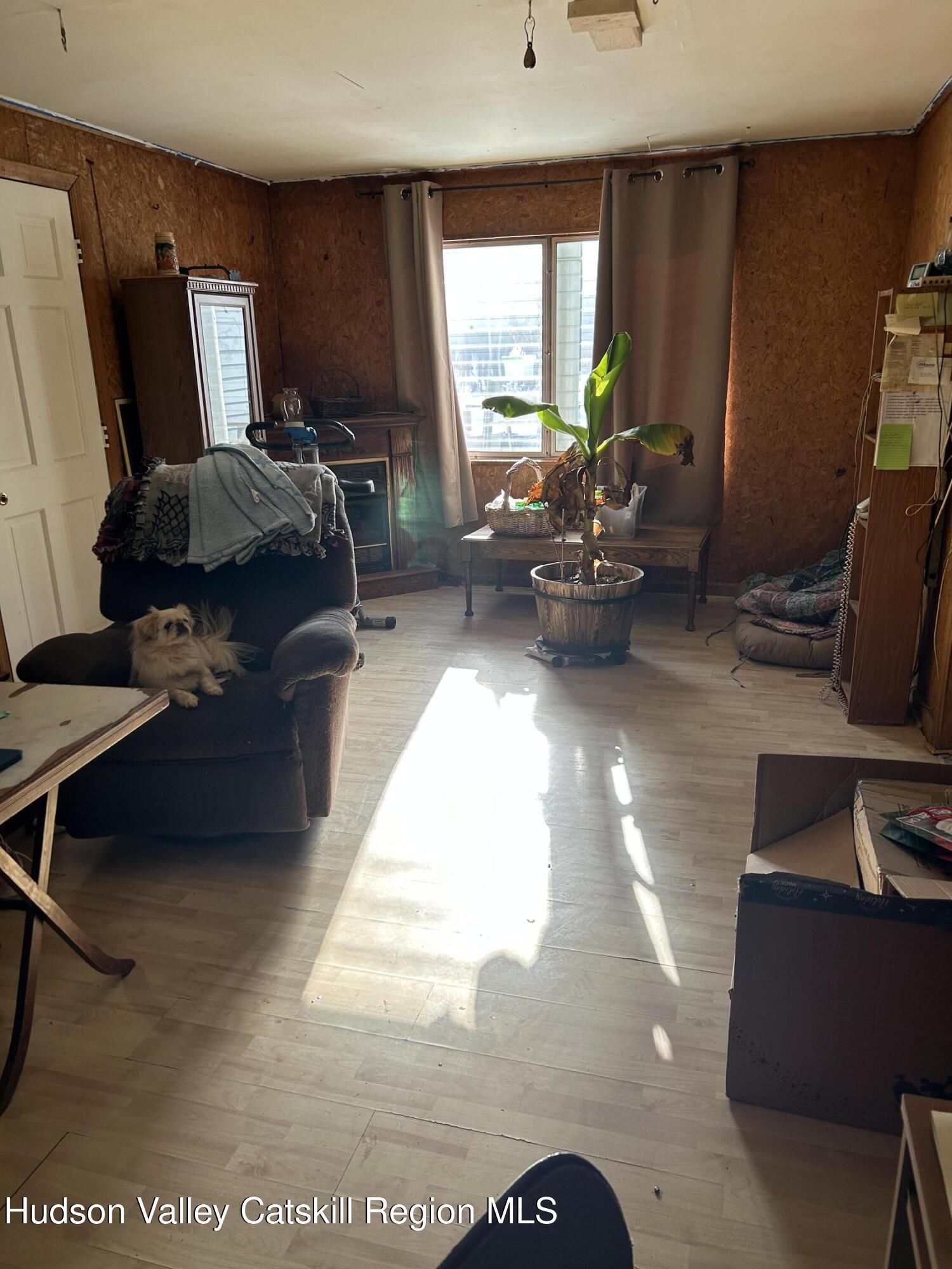 411 Plattekill Road Marlboro, NY 12542 - Photo 19 of 26 a living room with furniture a window and a flat screen tv