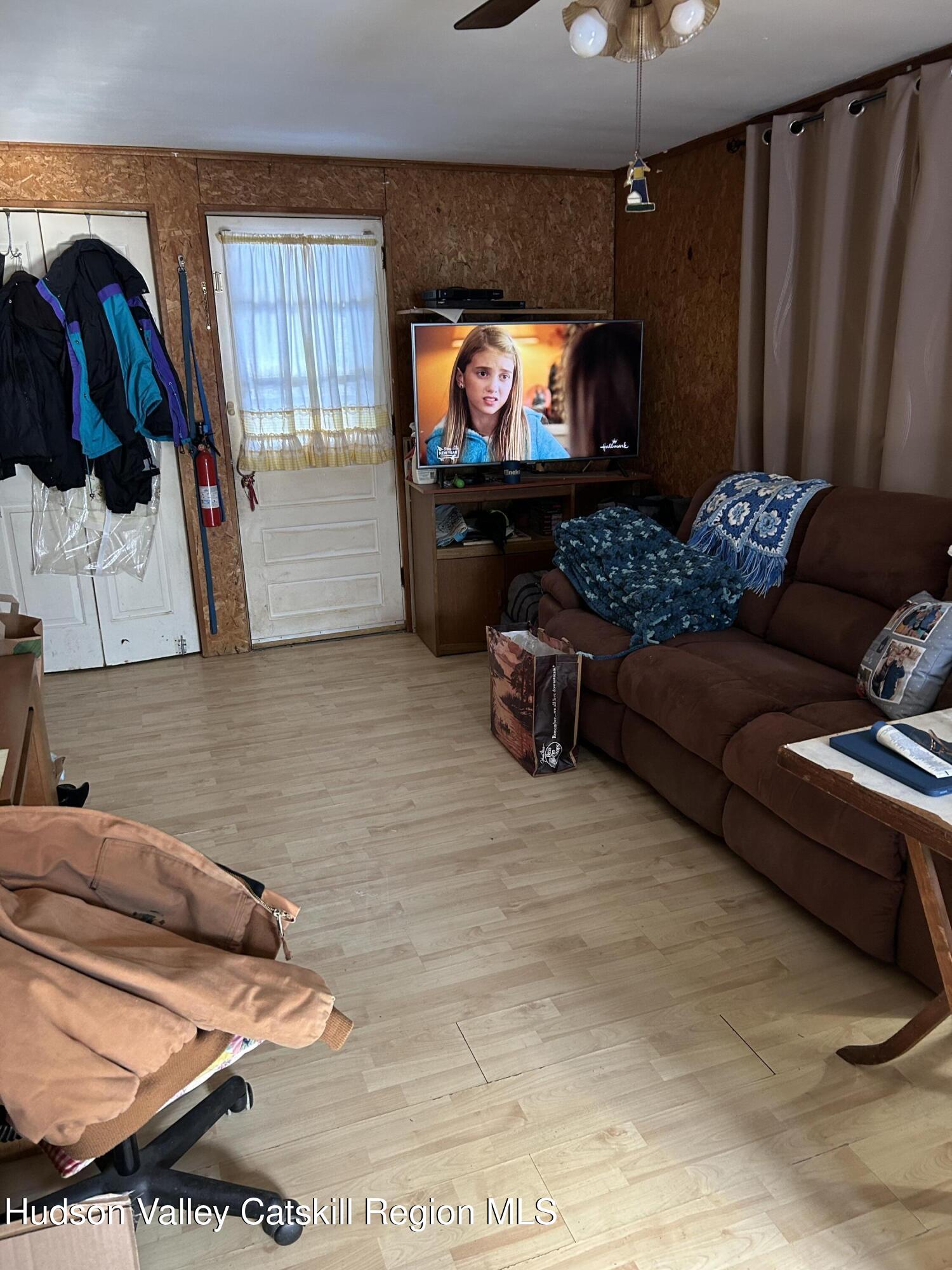 411 Plattekill Road Marlboro, NY 12542 - Photo 20 of 26 a living room with furniture and a flat screen tv