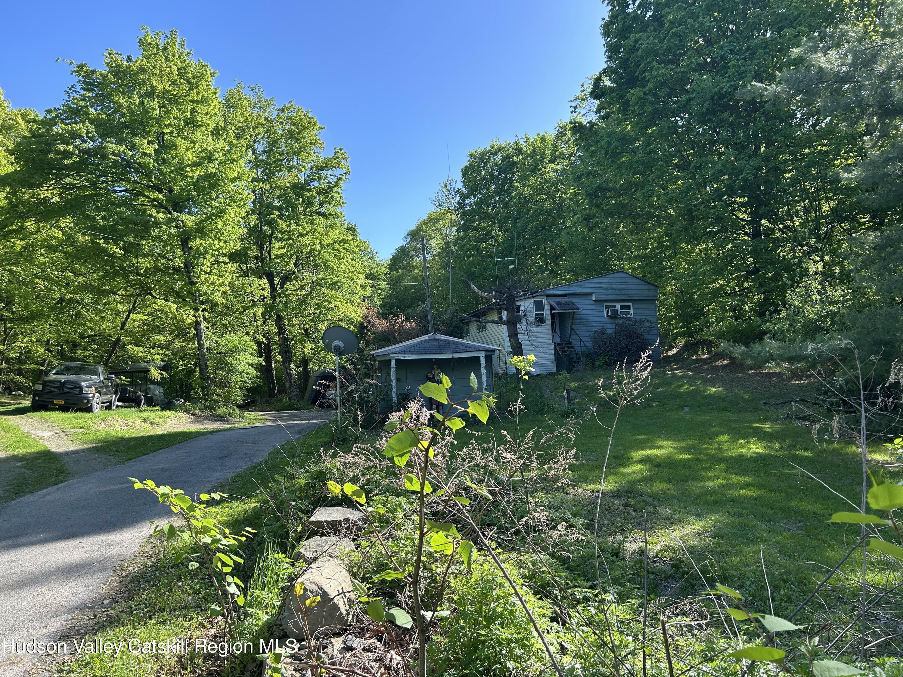 411 Plattekill Road Marlboro, NY 12542 - Photo 2 of 26 a backyard of a house with a garden and plants
