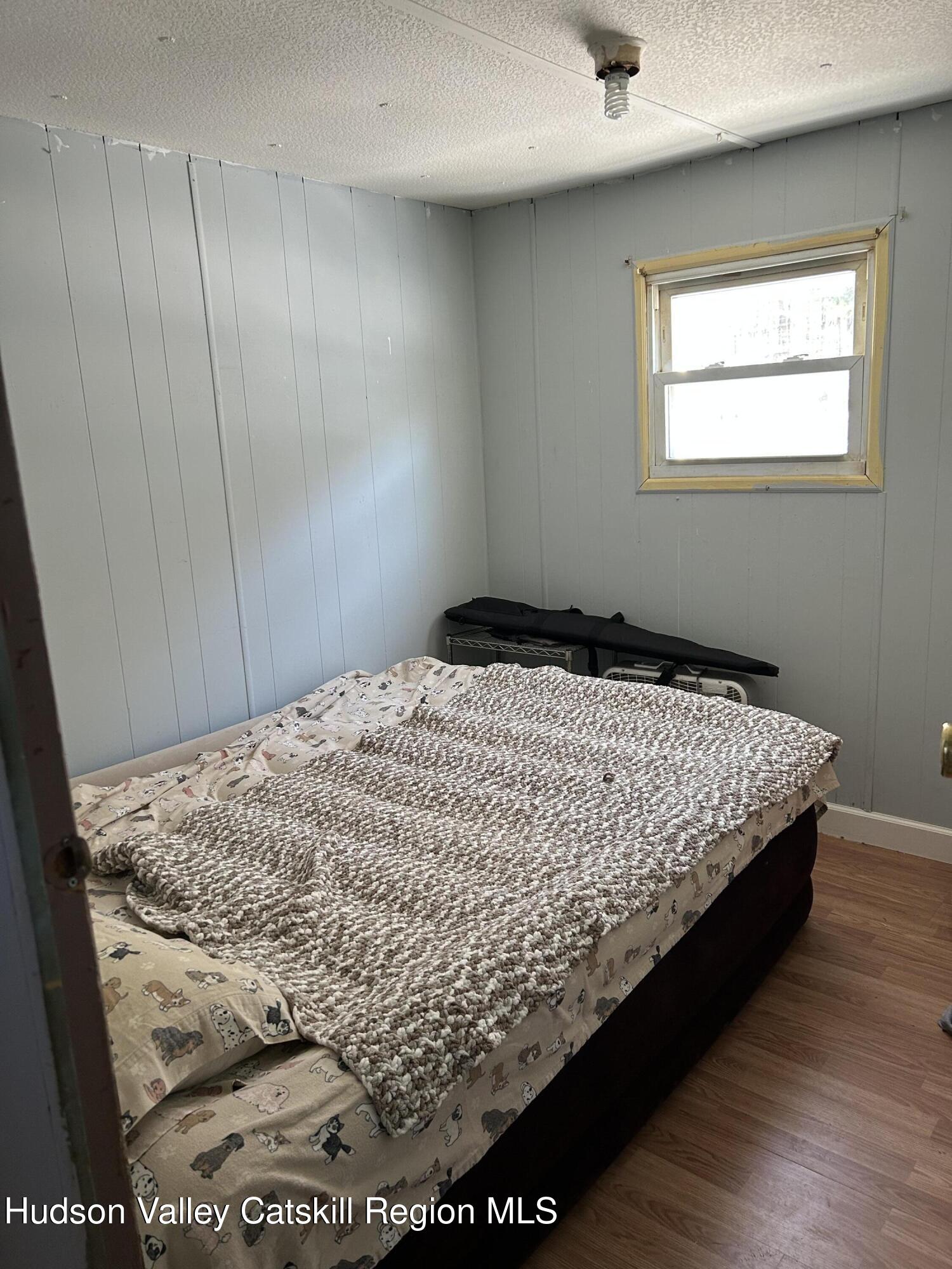 411 Plattekill Road Marlboro, NY 12542 - Photo 23 of 26 a bed sitting in a bedroom next to a window