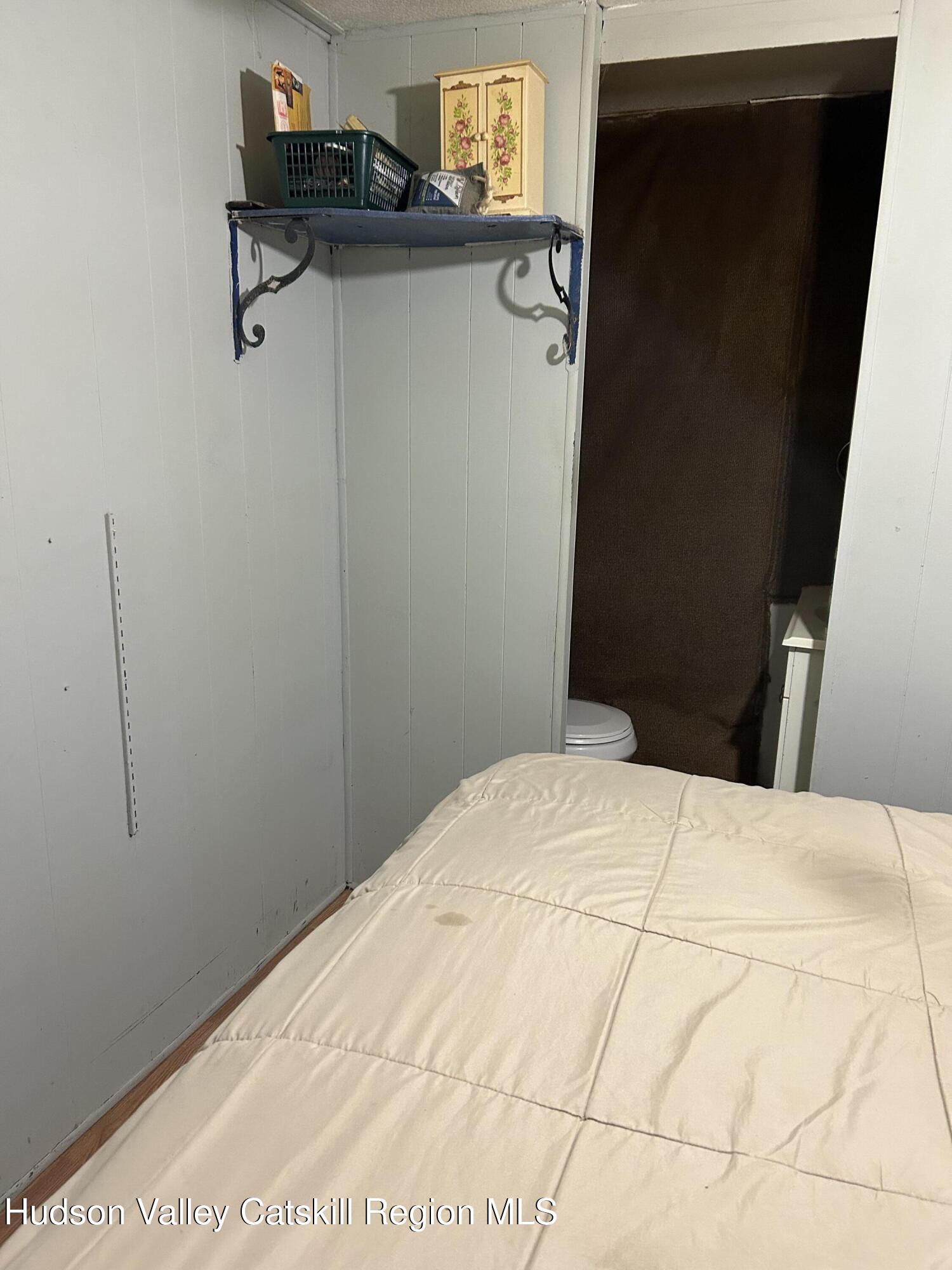 411 Plattekill Road Marlboro, NY 12542 - Photo 26 of 26 a bedroom with a bed and cabinets