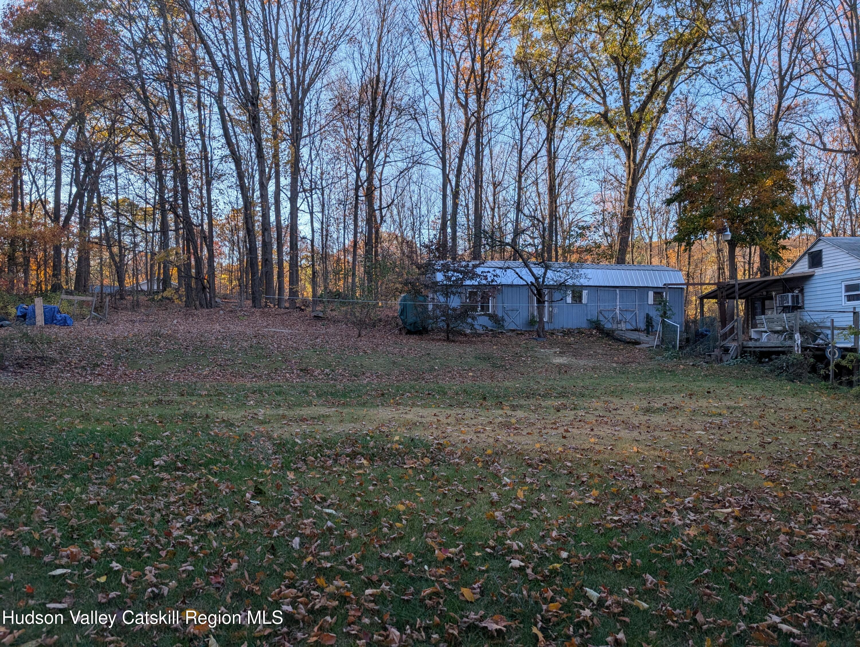 411 Plattekill Road Marlboro, NY 12542 - Photo 3 of 26 a view of a house with a yard covered with snow and trees
