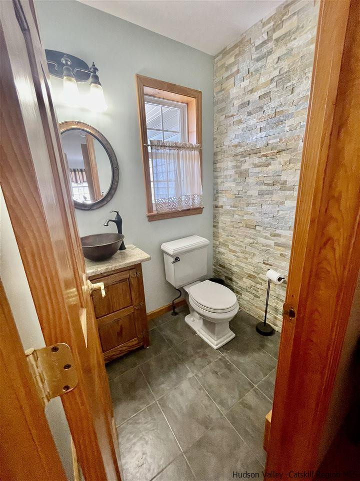 3 Knolls Road, Unit 1 Wallkill, NY 12589 - Photo 12 of 33 a bathroom with a toilet a sink and a mirror