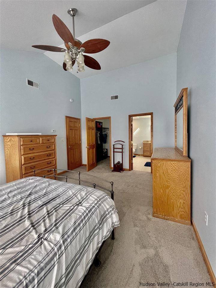 3 Knolls Road, Unit 1 Wallkill, NY 12589 - Photo 14 of 33 a bedroom with a bed and dresser with mirror