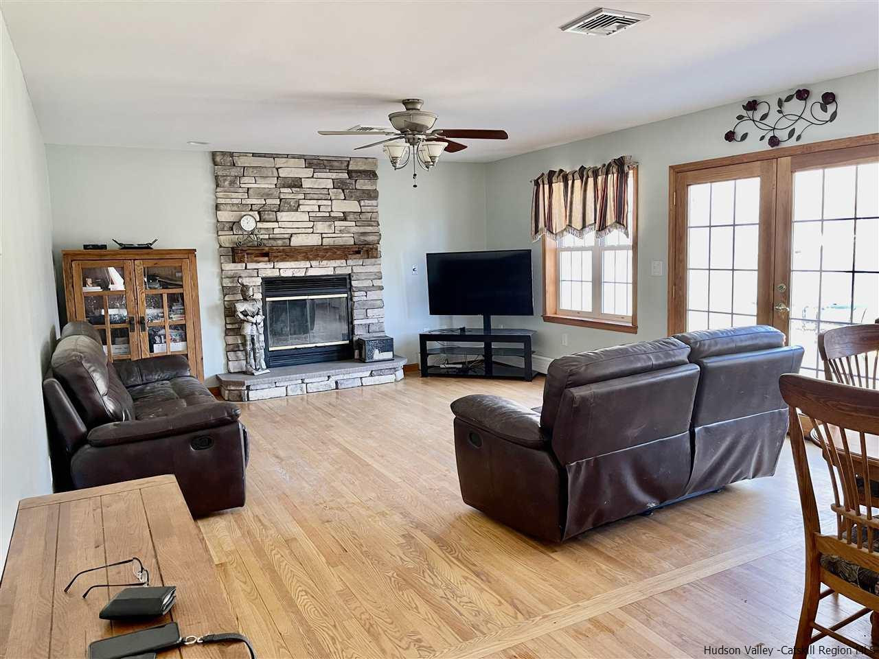 3 Knolls Road, Unit 1 Wallkill, NY 12589 - Photo 9 of 33 a living room with furniture a fireplace and a flat screen tv