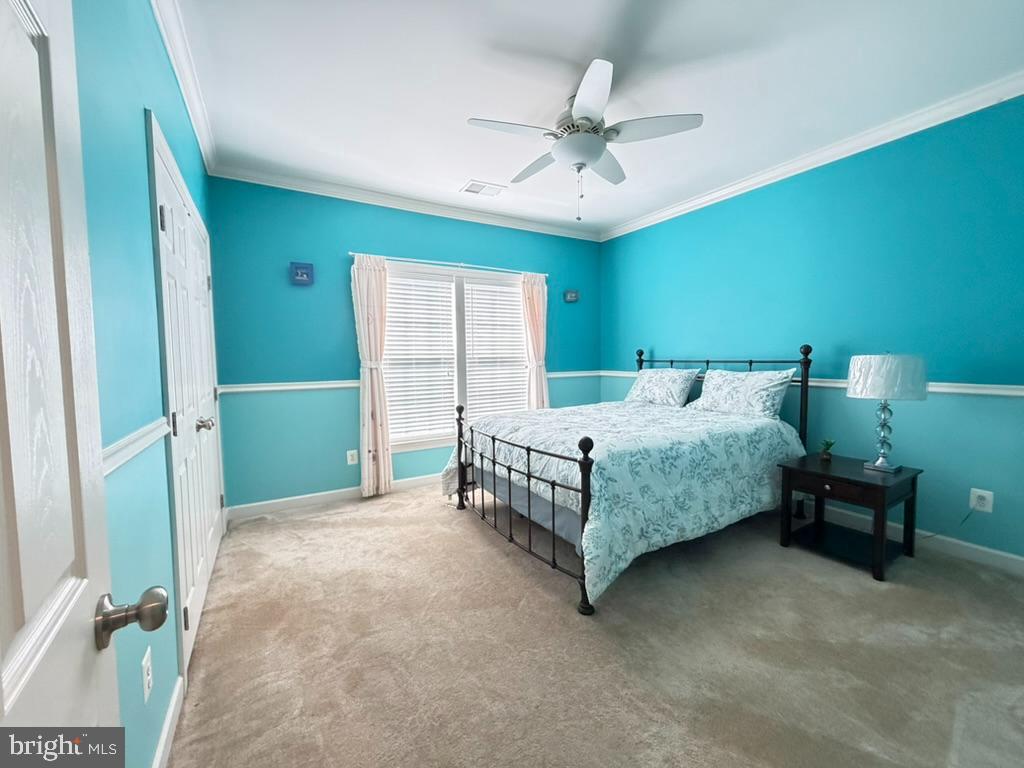 9804 Anvil Court Perry Hall, MD 21128 - Photo 17 of 21 a bedroom with a bed and a chandelier