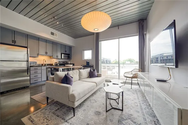 a living room with furniture and a large window