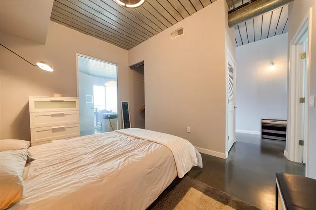 a bedroom with a bed and cabinets