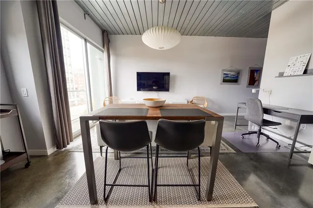 a view of a dining room with furniture and wooden floor