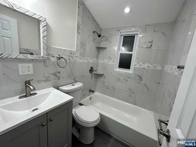 a bathroom with a sink toilet a shower and bathtub