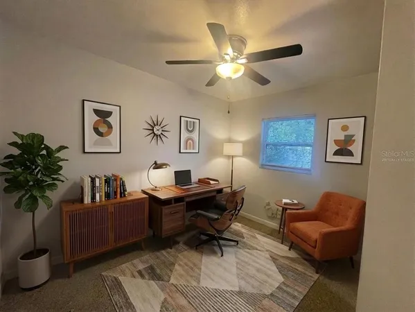 a living room with furniture and a potted plant