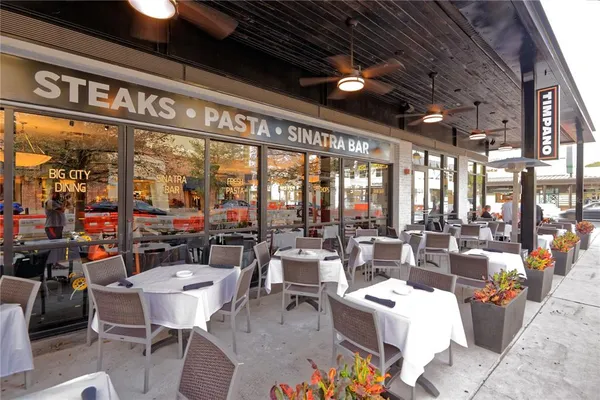 a living room with lots of furniture and a large window