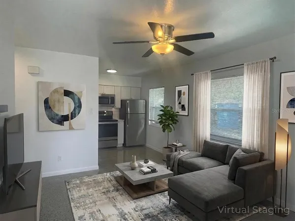 a living room with furniture and a large window