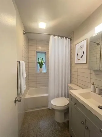 a bathroom with a toilet a sink and shower