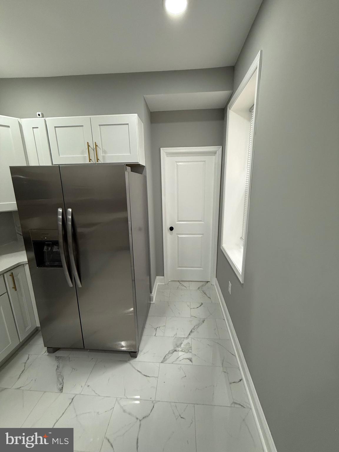 2122 West Toronto Street Philadelphia, PA 19132 - Photo 29 of 112 a view of a refrigerator in kitchen and an empty room