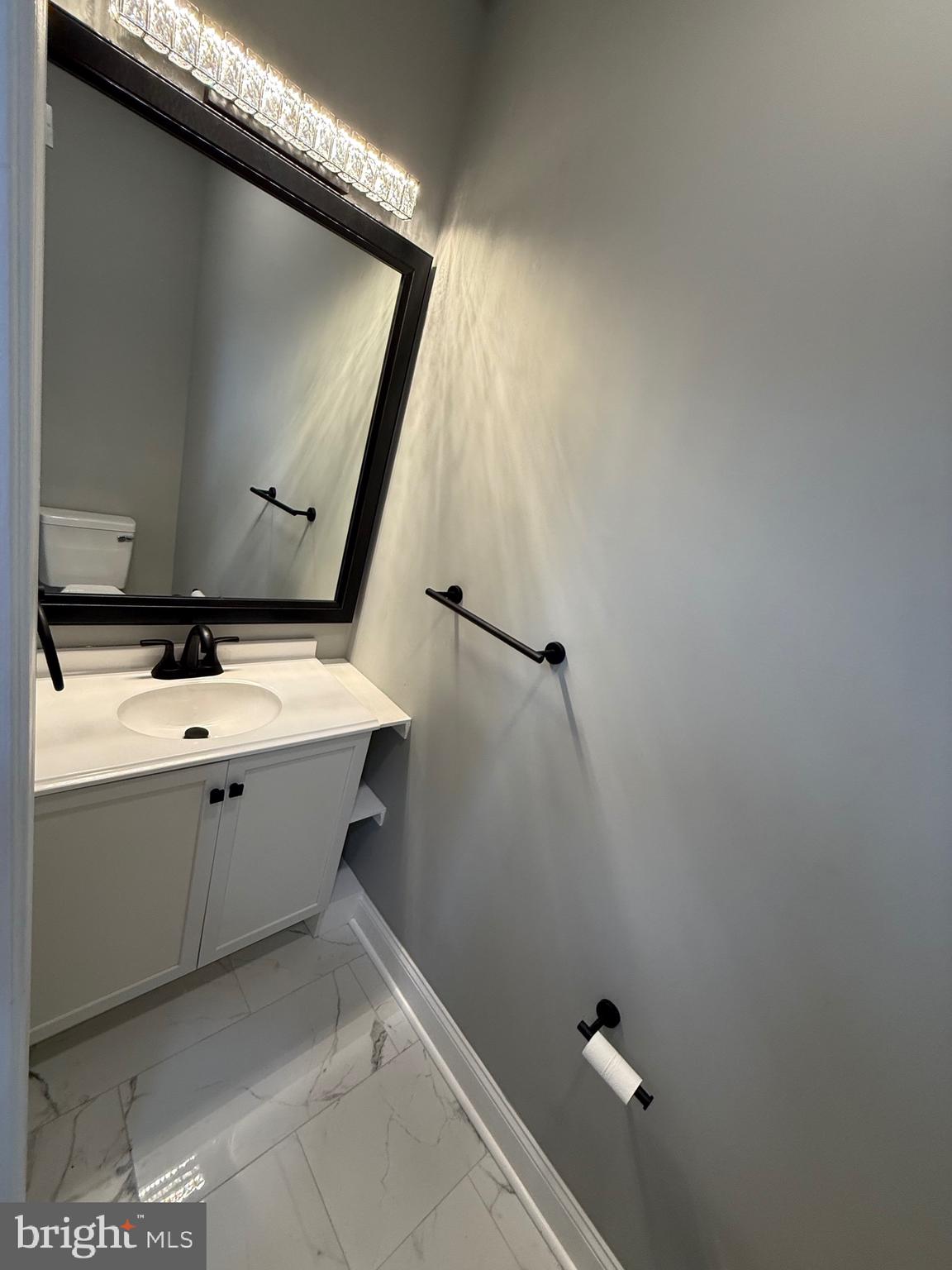 2122 West Toronto Street Philadelphia, PA 19132 - Photo 35 of 112 a bathroom with a sink and mirror with toilet