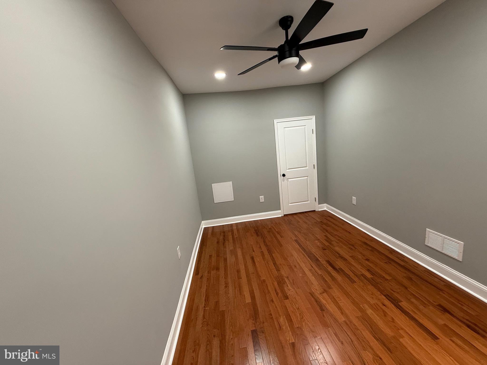 2122 West Toronto Street Philadelphia, PA 19132 - Photo 43 of 112 a view of a room with wooden floor and a ceiling fan