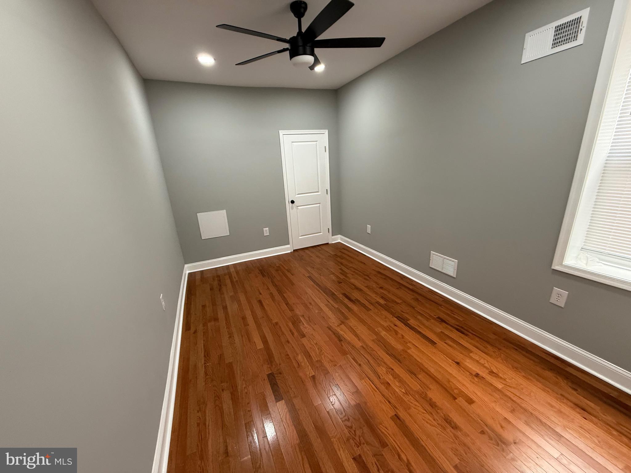 2122 West Toronto Street Philadelphia, PA 19132 - Photo 46 of 112 an empty room with wooden floor fan and windows