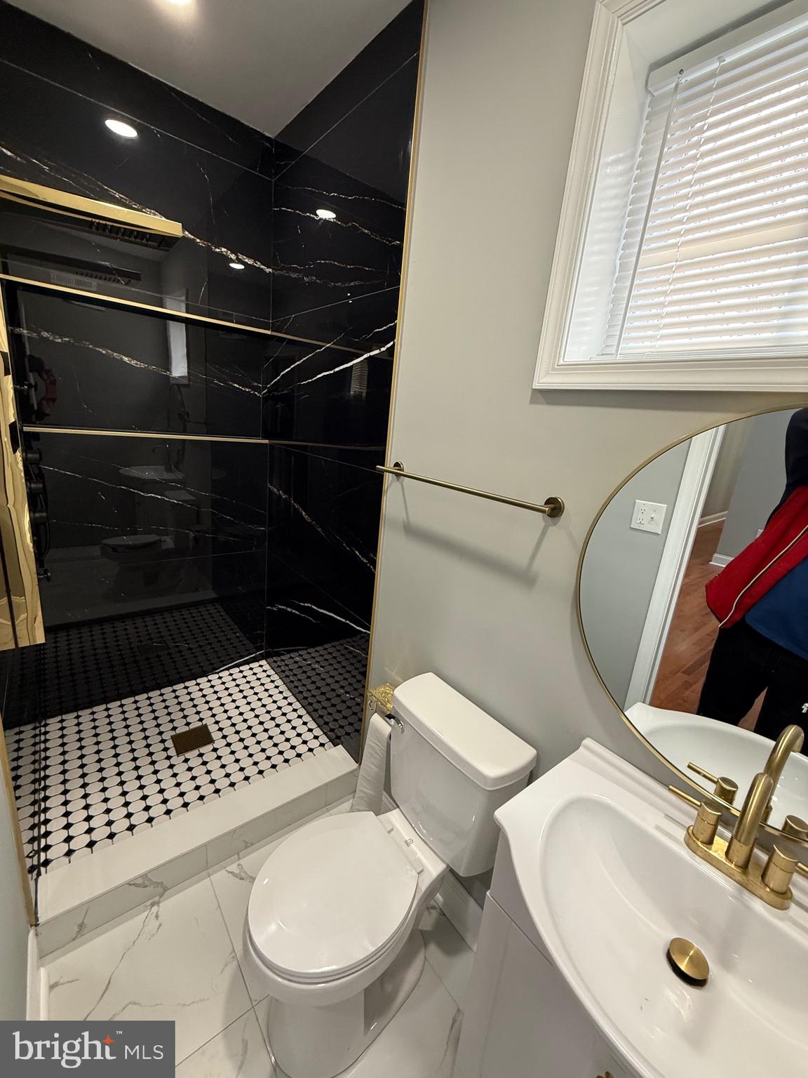 2122 West Toronto Street Philadelphia, PA 19132 - Photo 65 of 112 a bathroom with a sink a toilet and a mirror