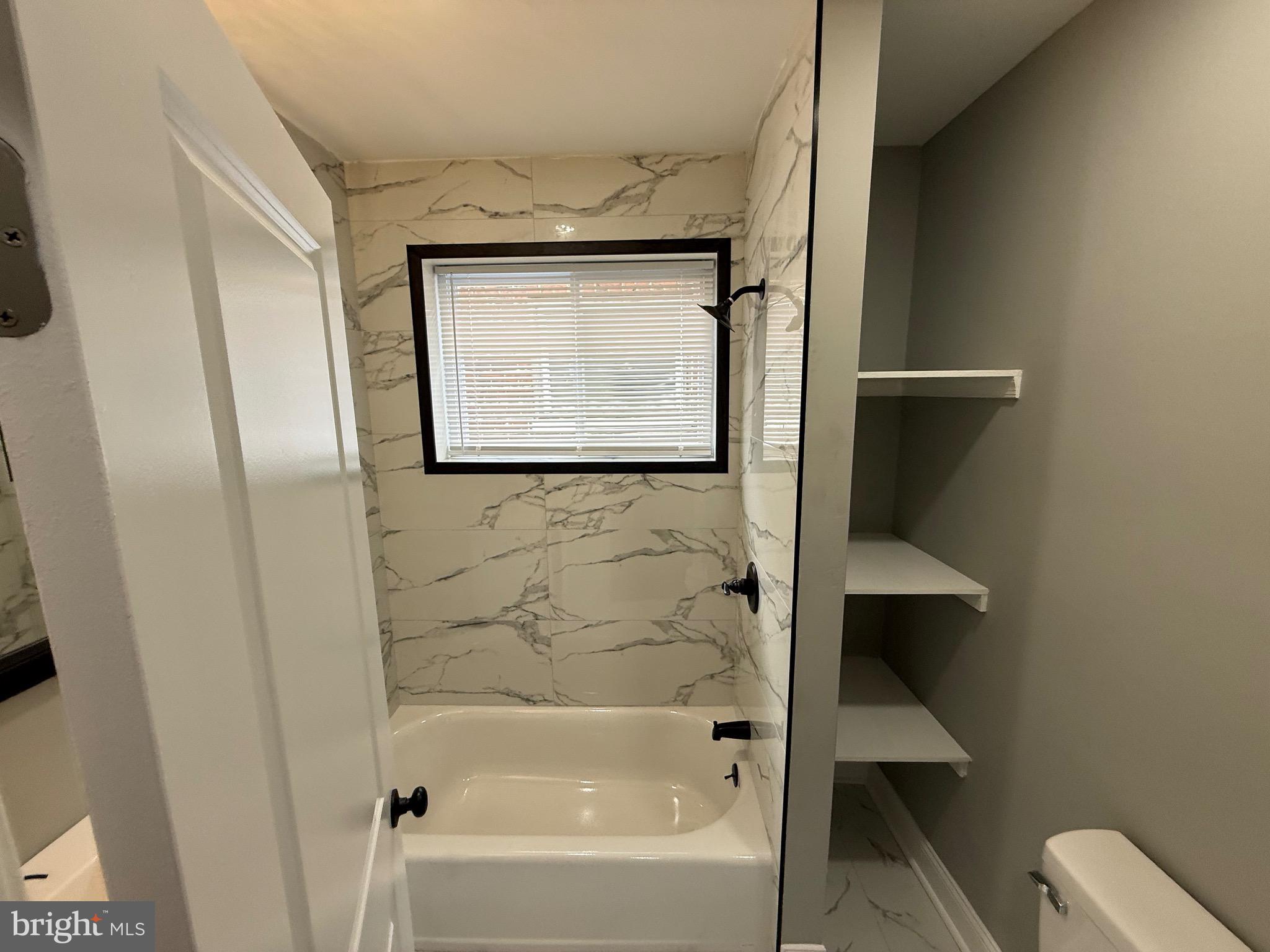 2122 West Toronto Street Philadelphia, PA 19132 - Photo 67 of 112 a bathroom with a bathtub and a shower
