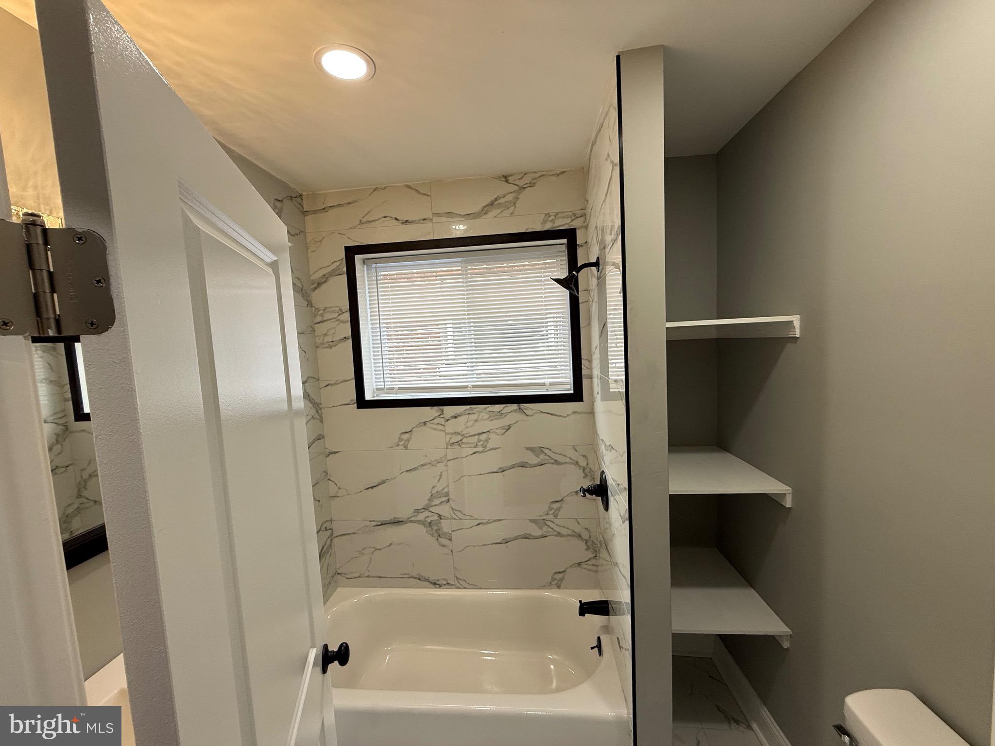 2122 West Toronto Street Philadelphia, PA 19132 - Photo 69 of 112 a bathroom with a bathtub and a shower