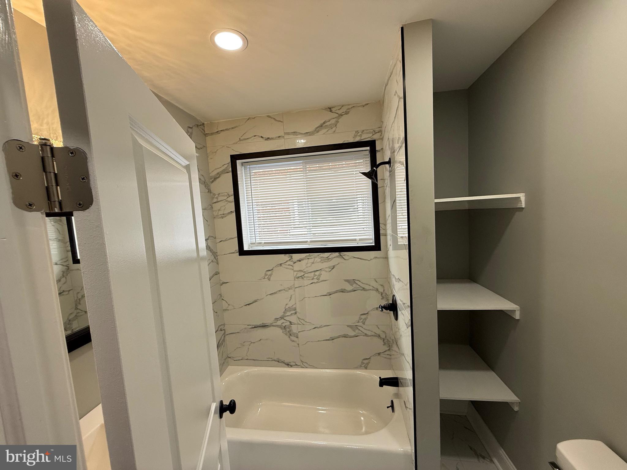 2122 West Toronto Street Philadelphia, PA 19132 - Photo 70 of 112 a bathroom with a bathtub and a shower