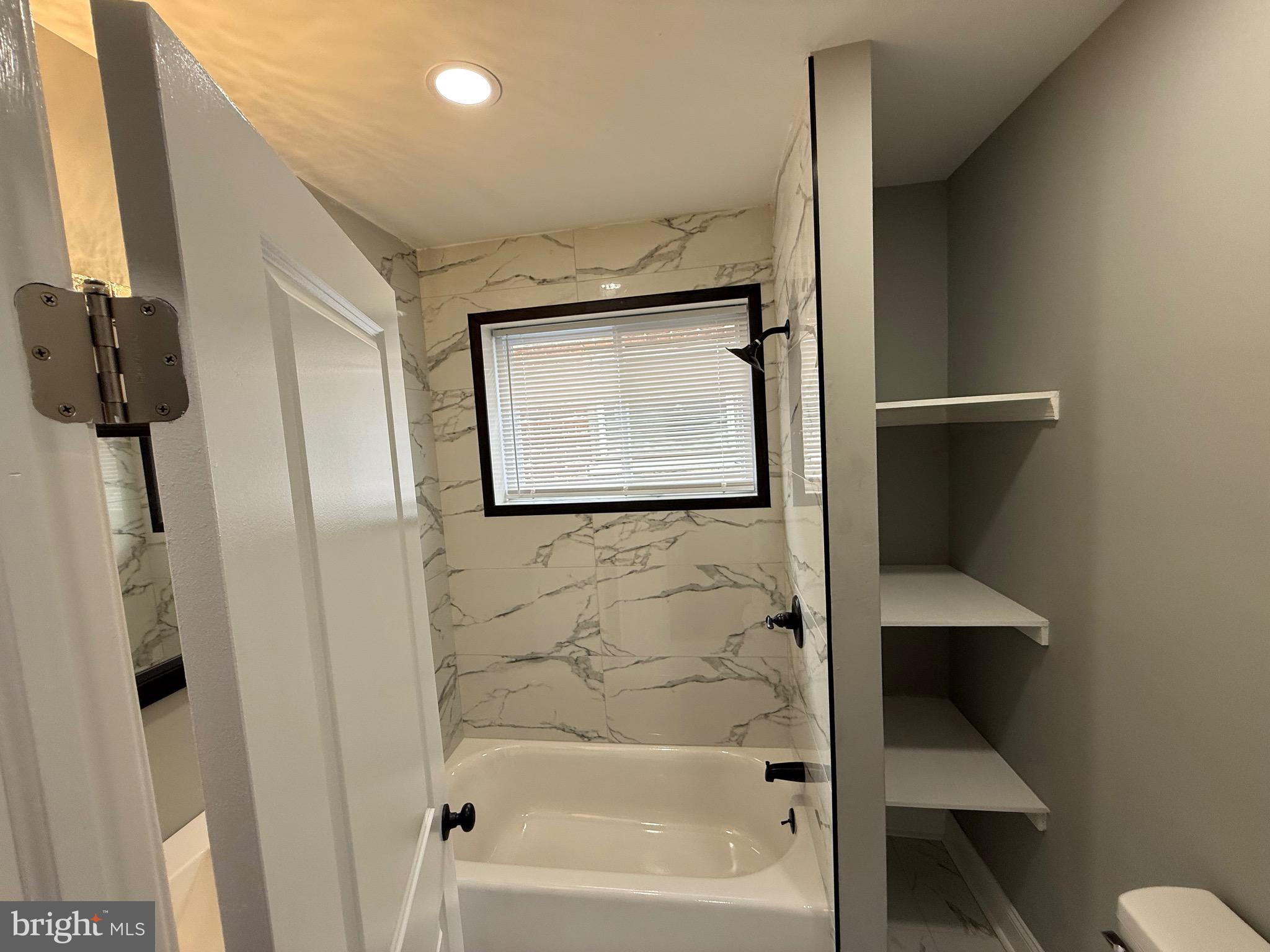 2122 West Toronto Street Philadelphia, PA 19132 - Photo 74 of 112 a bathroom with a bathtub and a shower