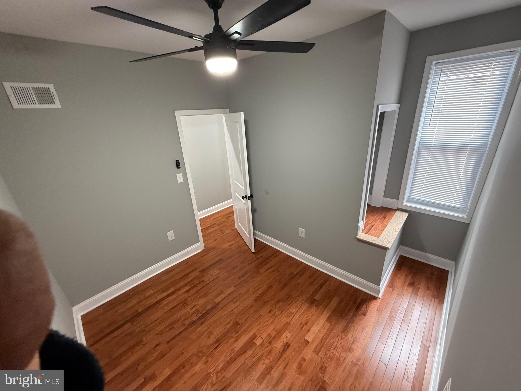 2122 West Toronto Street Philadelphia, PA 19132 - Photo 78 of 112 an empty room with wooden floor fan and windows