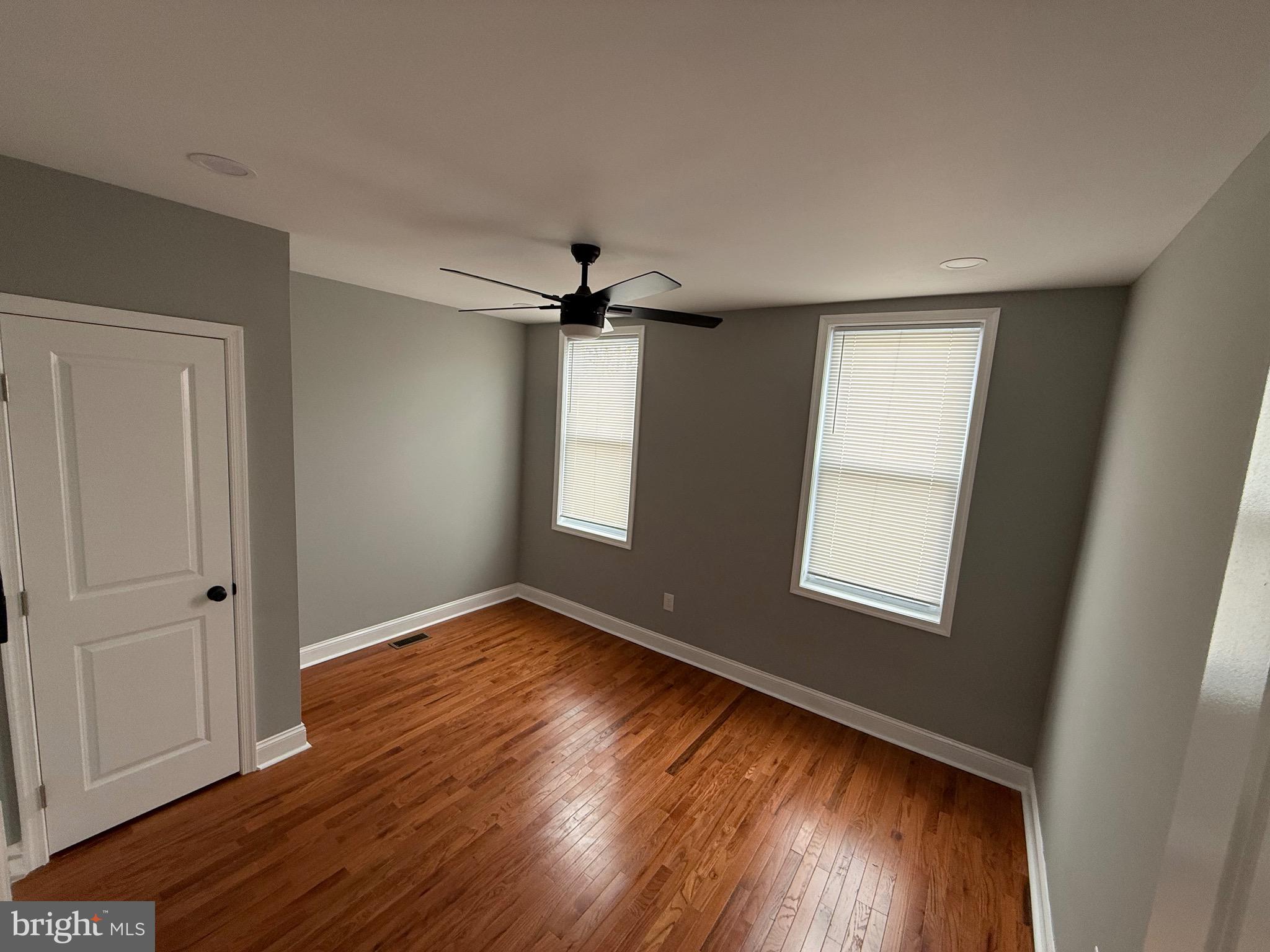 2122 West Toronto Street Philadelphia, PA 19132 - Photo 86 of 112 a view of an empty room with wooden floor and a window