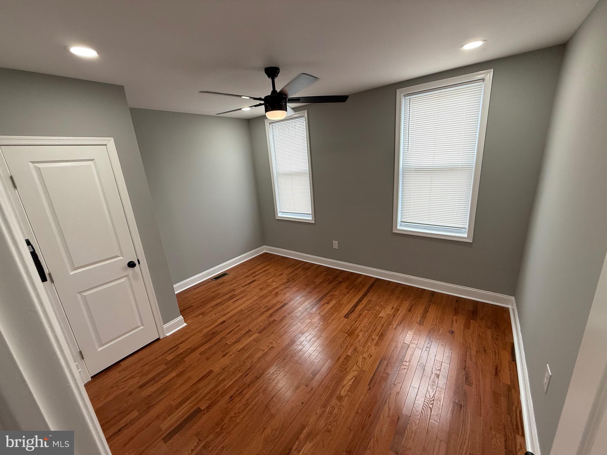 2122 West Toronto Street Philadelphia, PA 19132 - Photo 88 of 112 an empty room with wooden floor fan and windows