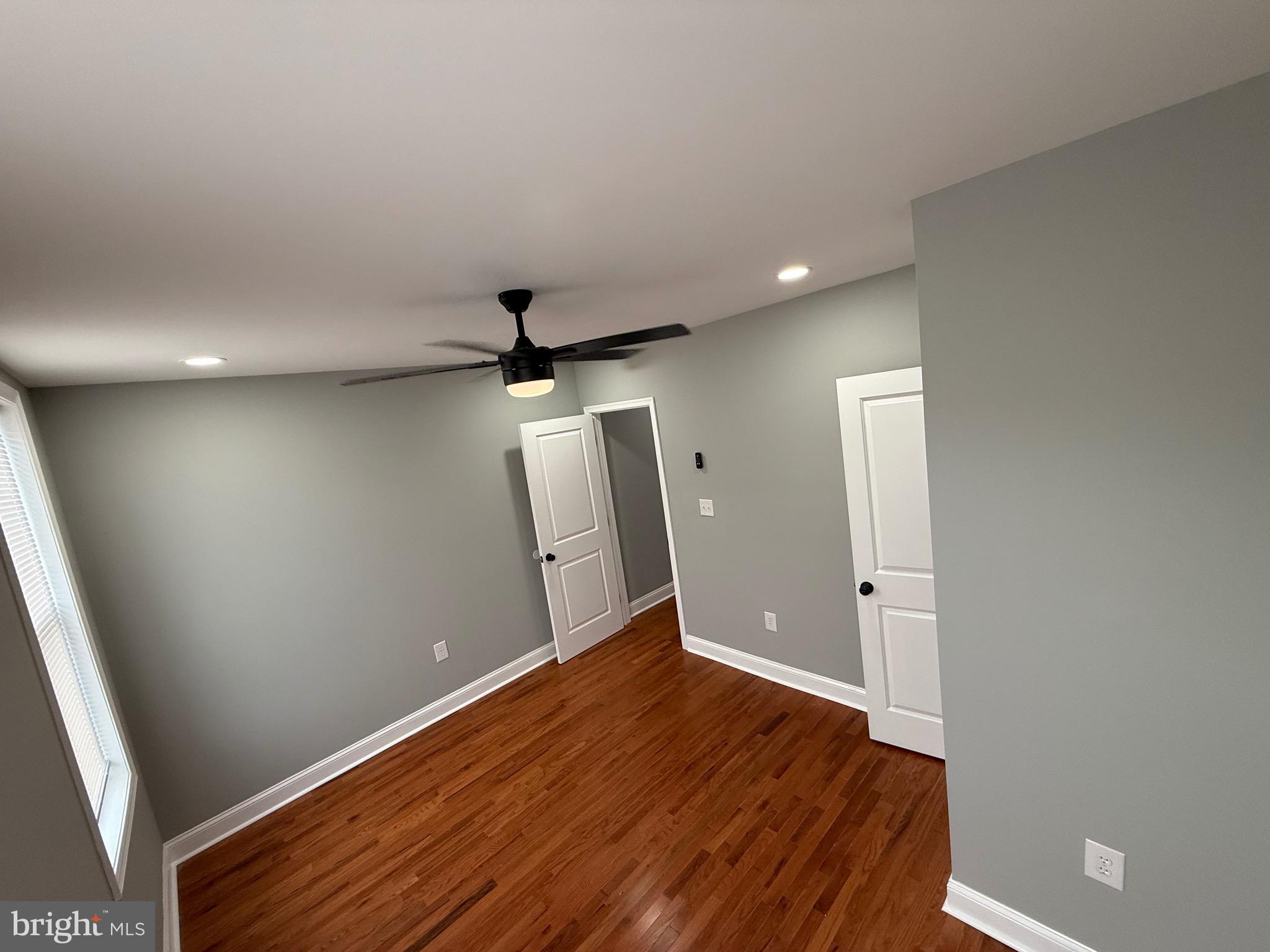 2122 West Toronto Street Philadelphia, PA 19132 - Photo 90 of 112 an empty room with wooden floor and a ceiling fan