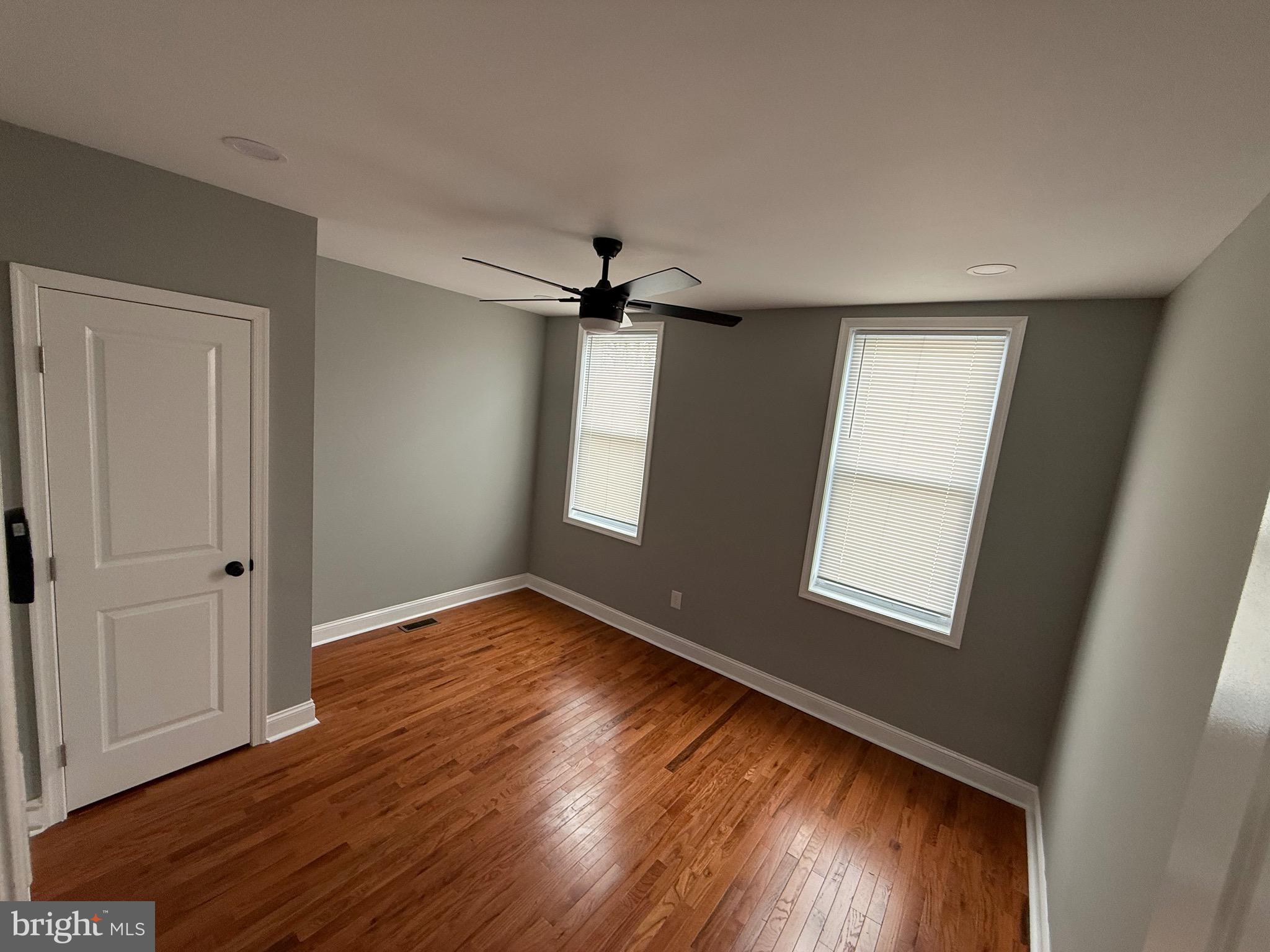 2122 West Toronto Street Philadelphia, PA 19132 - Photo 91 of 112 a view of an empty room with wooden floor and a window