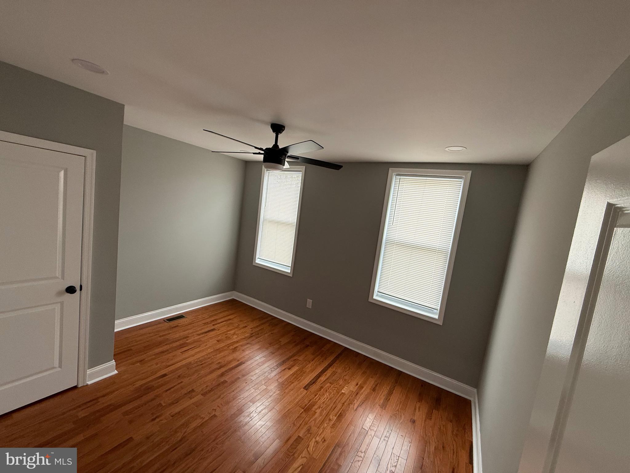 2122 West Toronto Street Philadelphia, PA 19132 - Photo 92 of 112 an empty room with wooden floor fan and windows
