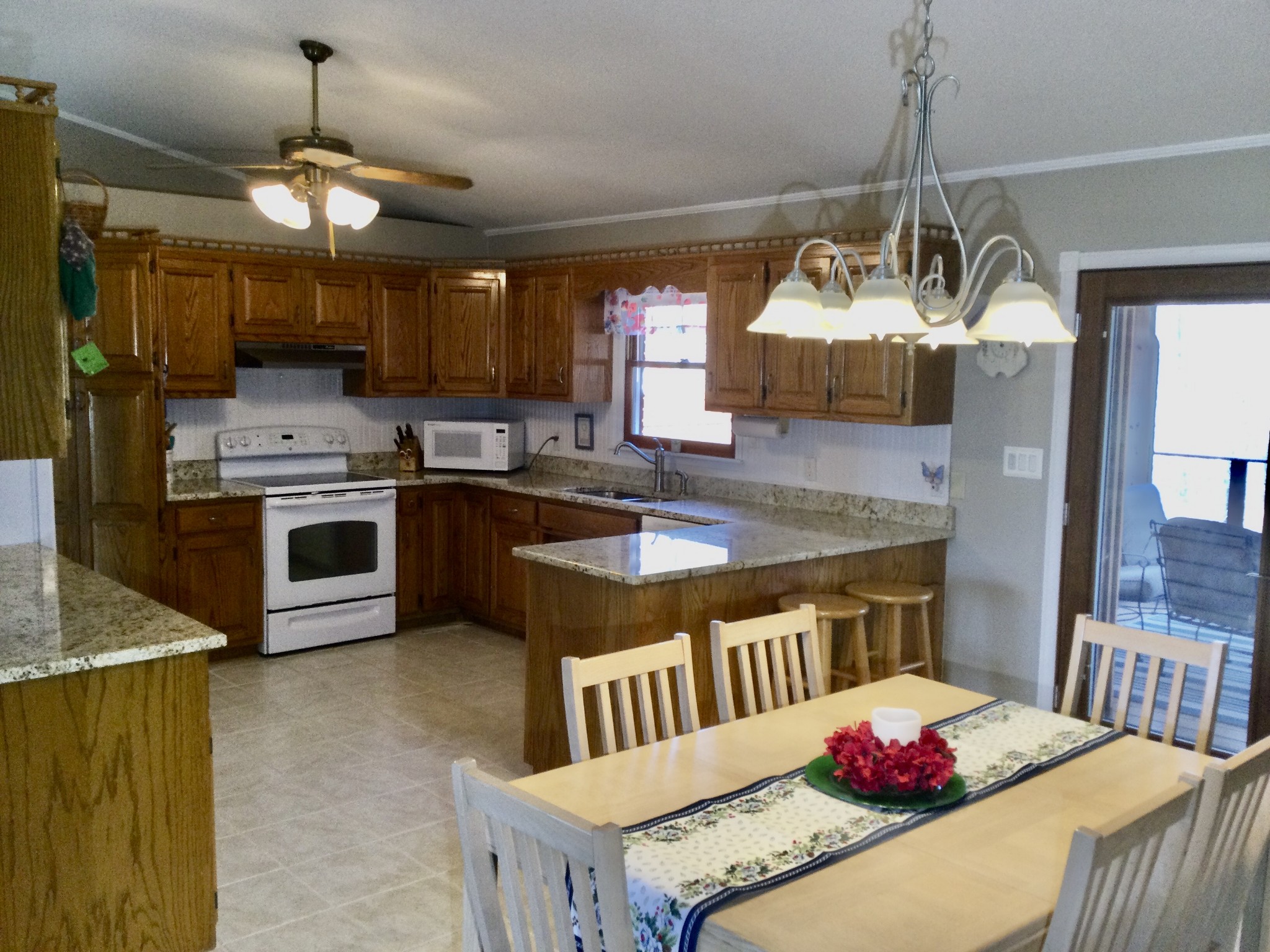 463 Dripping Springs Road Winchester, TN 37398 - Photo 14 of 25 a kitchen with stainless steel appliances granite countertop a sink a stove a refrigerator a center island a dining table and chairs