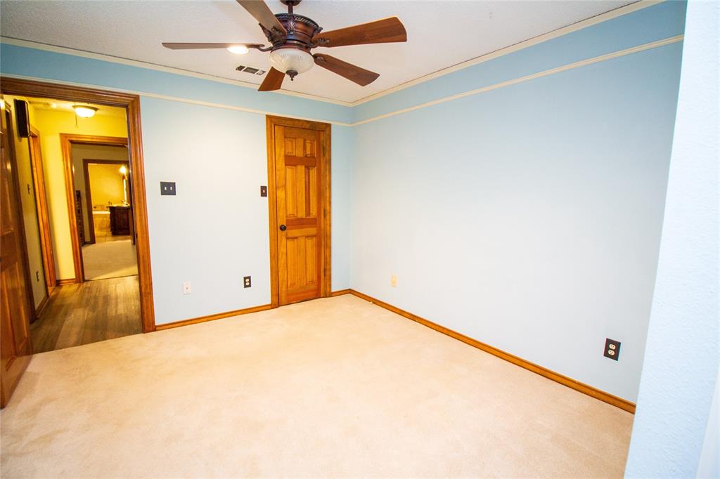3014 Pecan Ridge Drive Rowlett, TX 75088 - Photo 19 of 29 a view of a room with a ceiling fan and a window